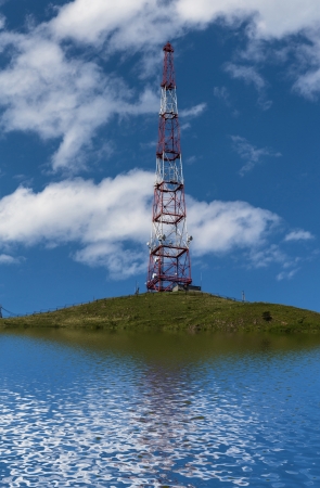  Telecommunications tower with reflection in water の写真素材