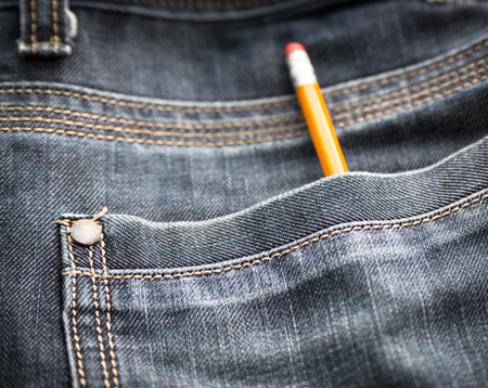  Blue jeans pocket with pencil - concept photo  Selective focus with shallow depth of field 