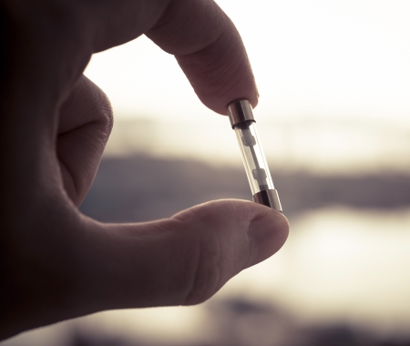    A hand holding fuse  Color toned image の写真素材