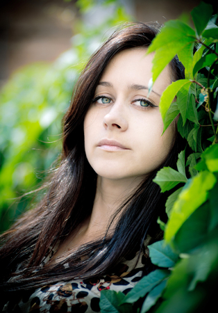  Portrait of a beautiful brunette on natural background  の写真素材