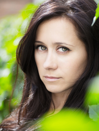  Portrait of a beautiful brunette on natural background  の写真素材