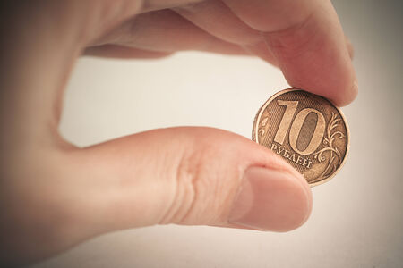 Coin in hand - ten rubles