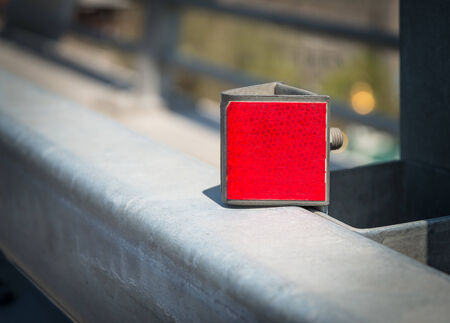   Red reflector on road - selective focus with shallow depth of field  の写真素材