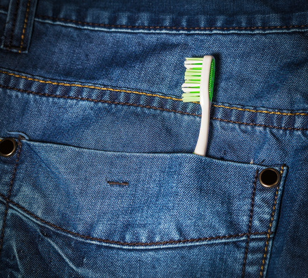   Toothbrush out of jeans pocket  Dental health concept  Selective focus on toothbrush   の写真素材