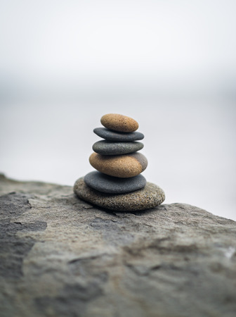  Stack of zen stones on rock in the fog  Selective soft focus の写真素材