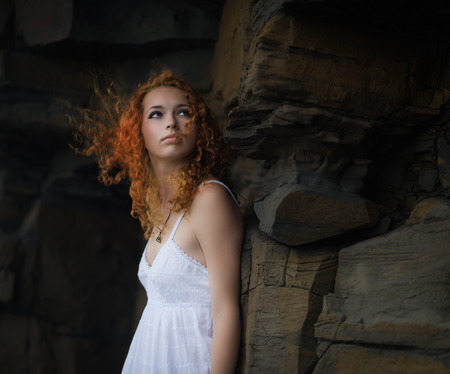   Beautiful redhead woman in a white dress, outdoor   の写真素材