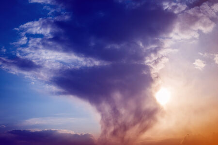 Colorful clouds and sun on the sky. Color toned image.