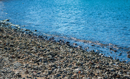 Wave of the sea on the rocky beach. Selective focus.の写真素材