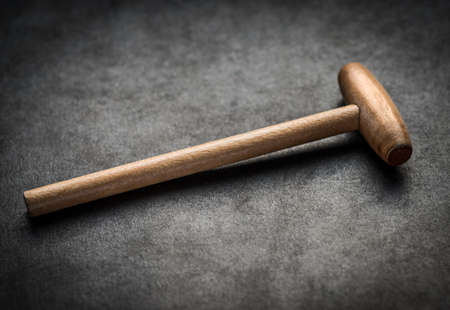 Wooden hammer on dark background. Selective focus.の写真素材