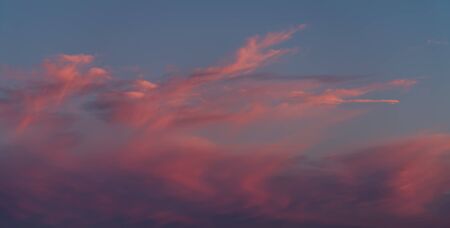 Dramatic sunset sky with orange colored clouds.の写真素材