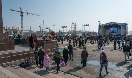 VLADIVOSTOK, RUSSIA - FEBRUARY 23, 2015: People walk on the town square during festivities devoted to Defender of the Fatherland Day.のeditorial素材