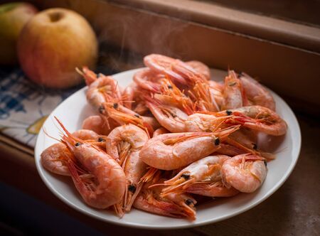 Cooked shrimps on white plate. Selective focus with shallow depth of field.の写真素材