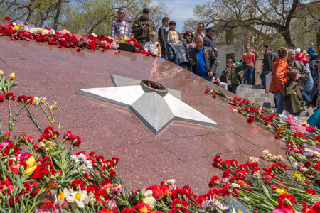 VLADIVOSTOK RUSSIA MAY September 2015: Eternal fire surrounded by flowers on May 9th in day of Victory.のeditorial素材