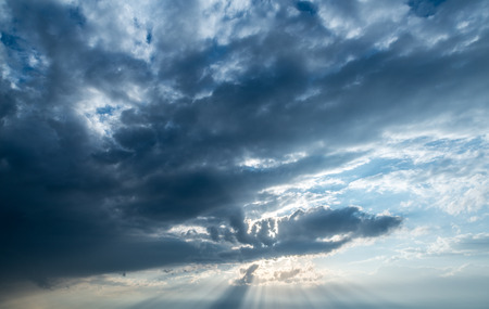 Dramatic sunset sky with dark clouds.