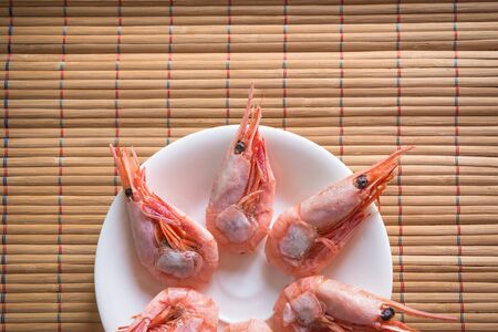Cooked shrimps on white plate. Selective focus and shallow depth of field.