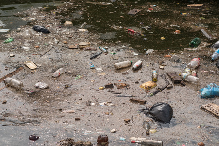 Oil and garbage pollution in the water. Selective focus with shallow depth of field.