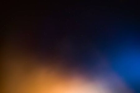 Night sky with colorful cloud and stars.