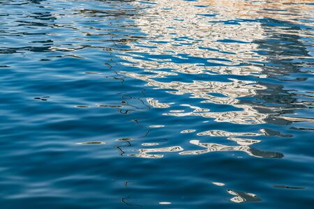 Blue sea surface with reflection.