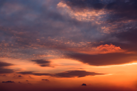 Dramatic sunset sky with orange colored clouds.の写真素材