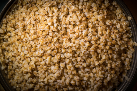 Cooking buckwheat groats on a stove. Selective focus.の写真素材