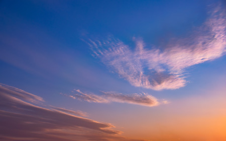 Dramatic sunset sky with orange colored clouds.