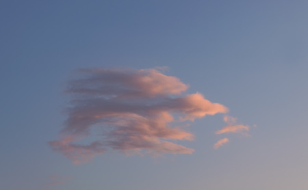 Single cloud on sunset sky.の写真素材