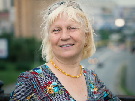 Portrait of beautiful aged woman in the park. Selective soft focus on eyes.の写真素材