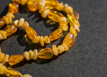 Amber necklace on dark background. Selective focus.の写真素材