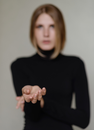 Portrait of beautiful young woman. Selective focus on hands.の写真素材