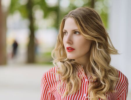 Outdoors portrait of beautiful young woman. Selective focus.の写真素材