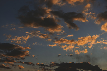 Beautiful sunset sky with orange clouds as natural background.
