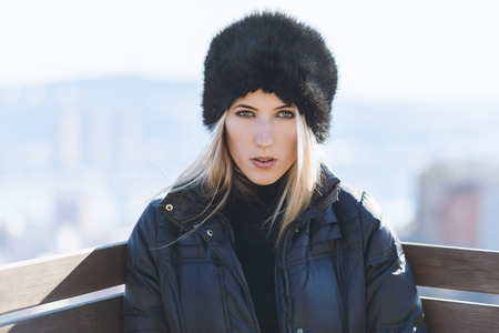 Portrait of young woman at sunny winter day.の写真素材