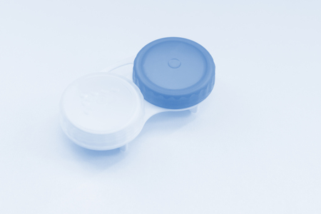 Contact lens case on light blue background. Selective focus.の写真素材