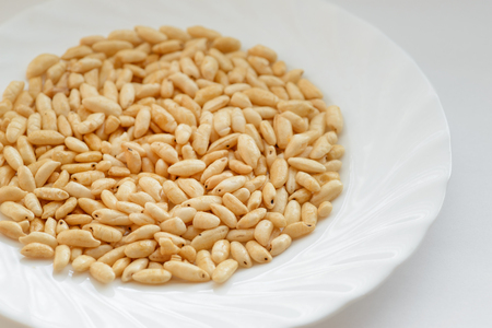 Puffed rice in white cup on white background.の写真素材
