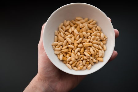 Puffed rice in white cup on dark background.の写真素材