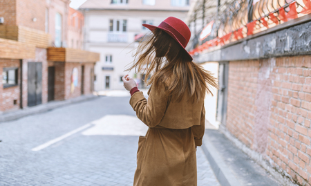 Portrait of a brunette girl in cloak. View from back.の写真素材