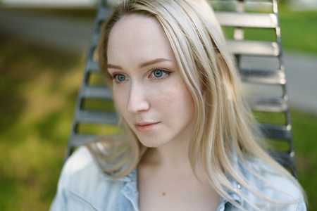 Summertime portrait of beautiful young woman with blue eyes. Selective focus.の写真素材