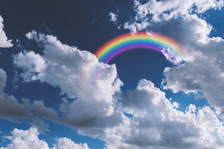 Colorful rainbow in clouds - beauty in nature concept.の写真素材