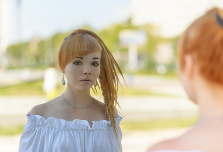 Portrait of a beautiful asian woman, outdoor. Reflection in the mirror.の写真素材