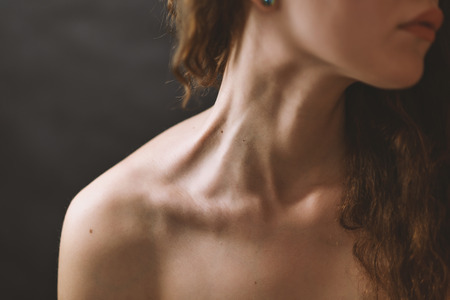 Girl's neck wtih dramatic light.の写真素材