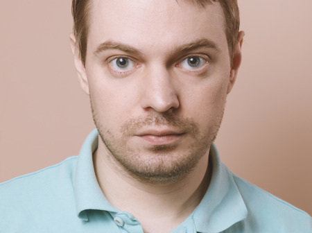 Portrait of a man on beige background.