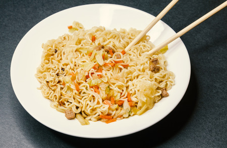 Instant noodles in white plate. Close-up.の写真素材