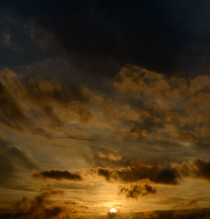 Dramatic sunset sky with dark clouds.の写真素材