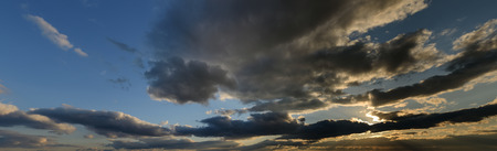 Beautiful sunset sky with dark-red clouds. Hi-res panorama.の写真素材