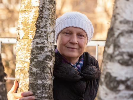 Portrait of a beautiful middle-aged woman, outdoors. Color toned.の写真素材