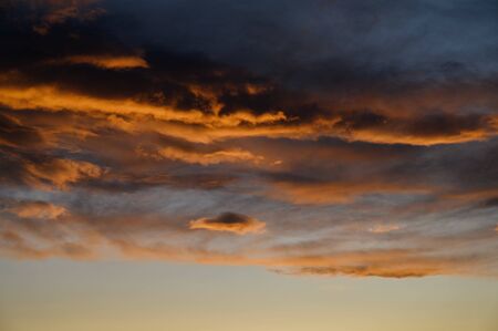 Dramatic sky with orange clouds. Nature background.の写真素材