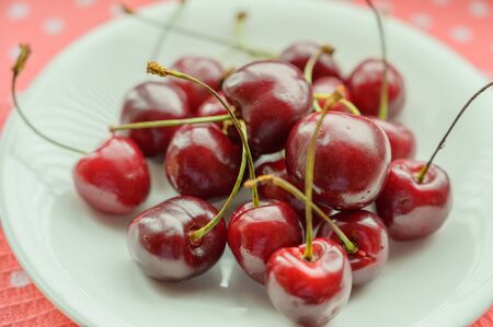 Cherry on the table in a cup. Selective focus.の写真素材