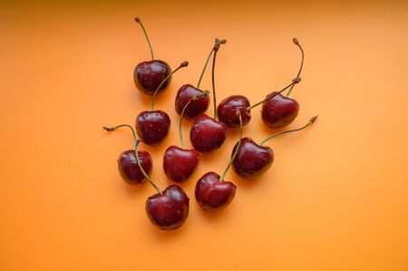 Natural looking cherry on a orange background. Selective focus.の写真素材