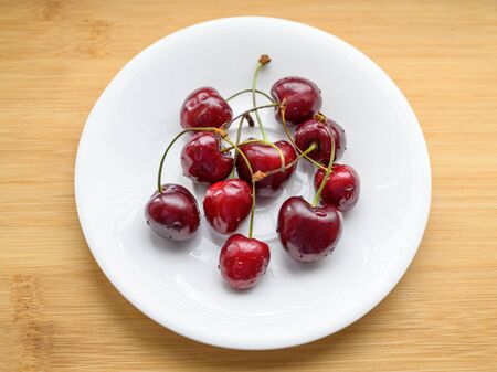 Cherry on the table in a cup. Selective focus.の写真素材