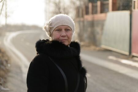 Winter portrait of a beautiful middle-aged woman in a fur coat.の写真素材